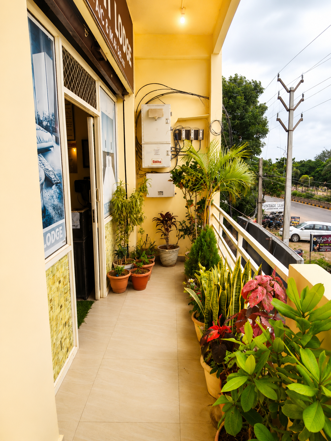 Lodge balcony with potted plants overlooking highway